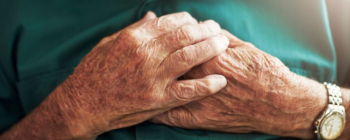 Man holding his hands over his chest