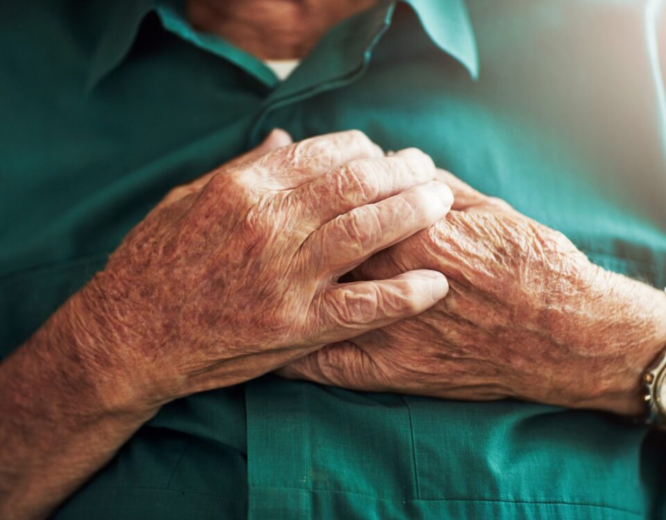 Man holding his hands over his chest
