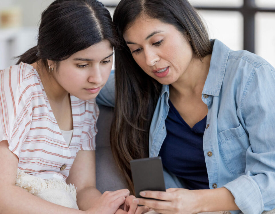 Two women looking at a smartphone