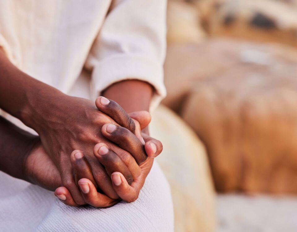 Young couple holding hands while sitting on a beach