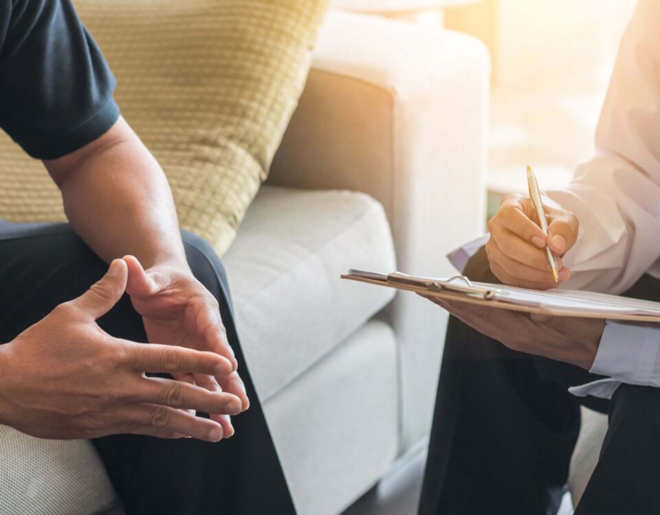 Doctor Consulting Male Patient Working On Diagnostic Examination On Mens Health Disease Or Mental Illness While Writing On Prescription Record Information Document In Clinic Or Hospital Office