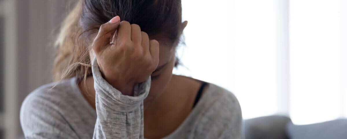 Woman with her hand on her head