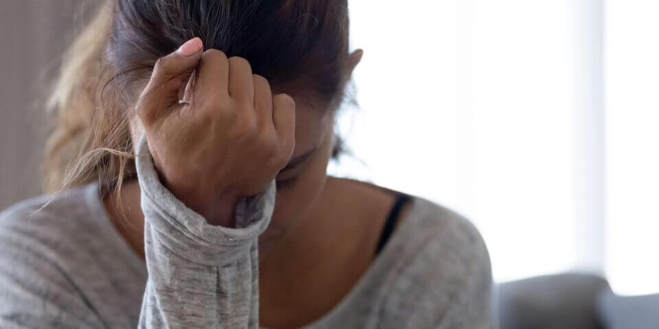 Woman with her hand on her head