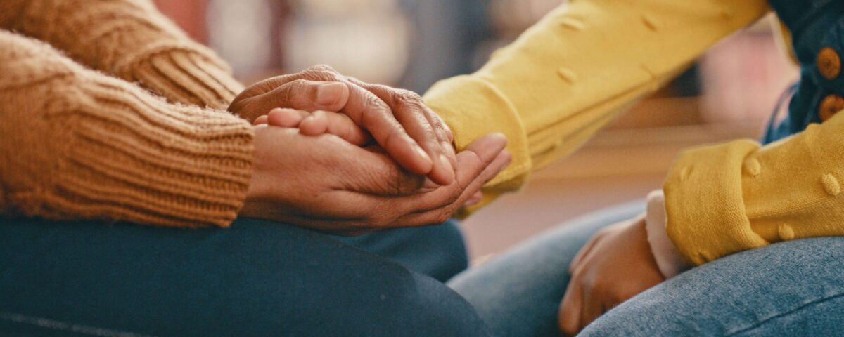 Someone's hand being held in comfort