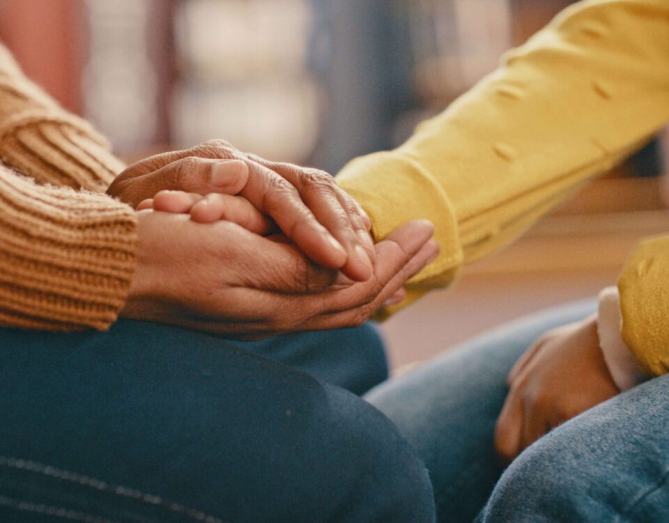 Someone's hand being held in comfort